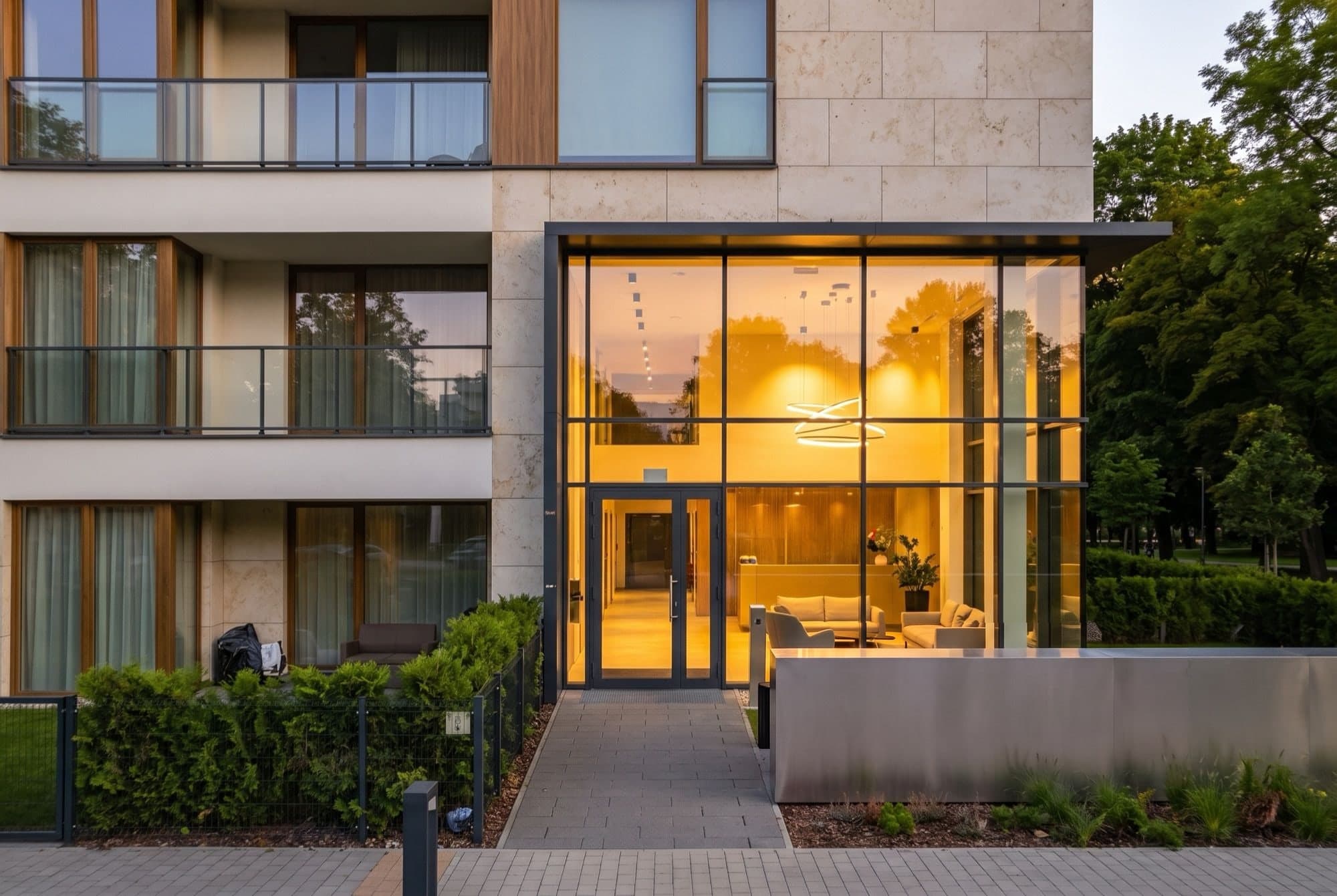 The Building 1 entrance, a double-height glazed lobby glowing at dusk behind the nameplate